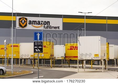 Dobroviz, Czech Republic - March 12: Dhl Shipping Containers In Front Of Amazon Logistics Building O