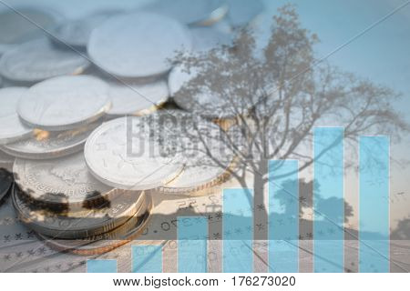 Double exposure of money coins with growing graph Blurred black tree silhouettes background Finance and banking concept.