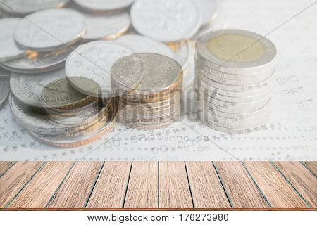 Double exposure of money coins stack for finance and banking concept Empty wood table top perspective wood can be used for display products.