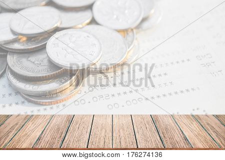 Double exposure of money coins for finance and banking concept Empty wood table top perspective wood can be used for display products.