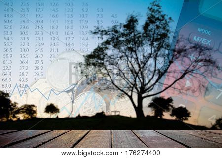 Double exposure of money coins for finance and banking concept Empty wood table top on blurred images black tree silhouettes for background.