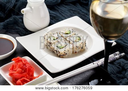 Sushi Roll On A White Plate, Decorated Like In Restaurant Over Dark Concrete Background