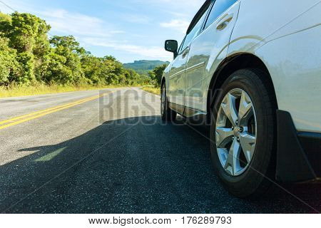 Asphalt road with cars passing through the forest and mountens Landscape in summer day. Toned effect. Stock photo