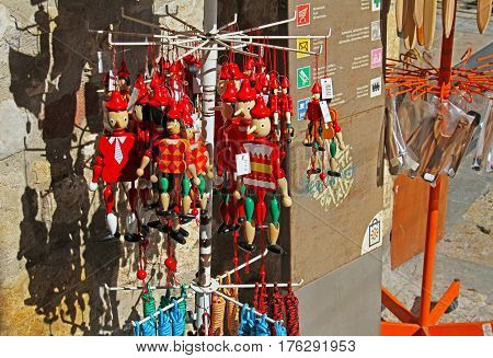 Besalu Spain - September 09 2014: Wooden pinocchio souvenirs on street market in Besalu (Catalonia Spain)