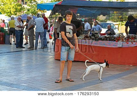 Besalu Spain - September 09 2014: Young man with his pet in the market in Besalu (Catalonia Spain)
