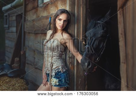 Woman and horse in a wooden shed in rural areas.