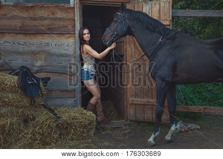 Beautiful woman and horse on a farm in the countryside.