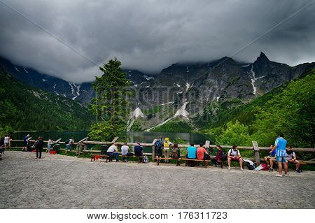 MORSKIE OKO POLAND - JUNE 19 2016: People wondering at Morskie Oko lake in Poland