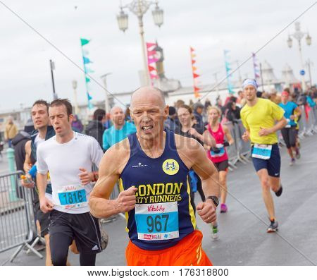 BRIGHTON GREAT BRITAIN - FEB 26 2017: Senior man and competitors running in the Vitality Brighton half marathon competition. February 26 2017 in Brighton Great Britain