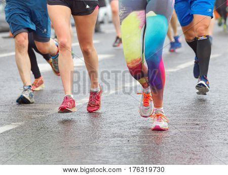 BRIGHTON GREAT BRITAIN - FEB 26 2017: Closeup of colorful running feet and legs in the Vitality Brighton half marathon competition. February 26 2017 in Brighton Great Britain