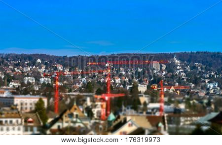 Big Cranes Over The City On Blue Sky Background