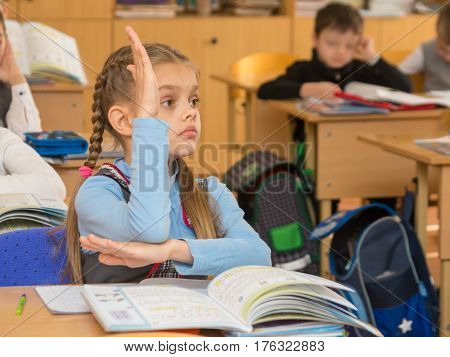 Girl Schoolgirl At A Lesson At School Wanting To Pull Your Hand Up To Answer A Question