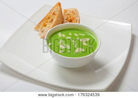 Asparagus Cream Soup In White Bowl With Bread