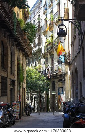 BARCELONA, SPAIN - March 10 2017: View looking down a narrow street in the Gothic Quarter Old Town of Barcelona Spain