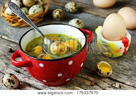 Traditional Easter soup with egg yolk in red bowl