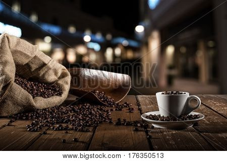 Background of cup of coffee beans with jute bag and bailer