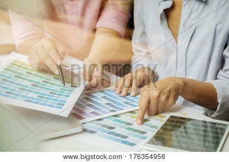 Graphic design and color swatches and pens on a desk. Architectural drawing with work tools and accessories.