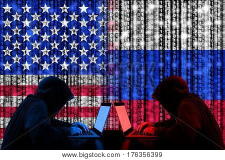 American hacker sitting opposite of a russian hacker cyberwar concept in front of binary flags
