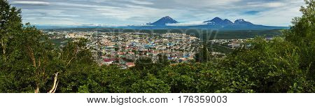 Summer panorama of Petropavlovsk-Kamchatsky on the background Avachinskaya group Volcano. View from Mishennaya hills.