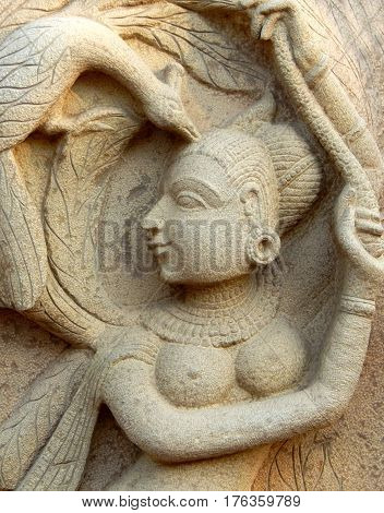 HYDERABAD,INDIA-MARCH 3:Stone carving of Indian Hindu woman, traditional architecture,play with hamsa a bird, in Shilparamam on March 3,2017 in Hyderabad,India