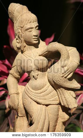 HYDERABAD,INDIA-MARCH 3:Stone carving of Indian Hindu woman, traditional architecture,carrying a duck,with details of ornaments and dress in Shilparamam on March 3,2017 in Hyderabad,India