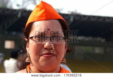 HYDERABAD,INDIA-MARCH 5:Portrait of Indian woman traditional Maharashtra style drummer with makeup,dress,jewelry and saffron color cap on March 5,2017 in Hyderabad,India