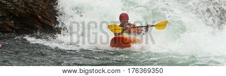 Kayaker in the waterfall in Norway Ula river