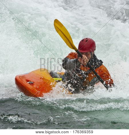 Kayaker in the waterfall in Norway Ula river