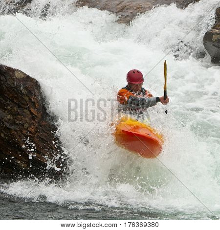 Kayaker in the waterfall in Norway Ula river