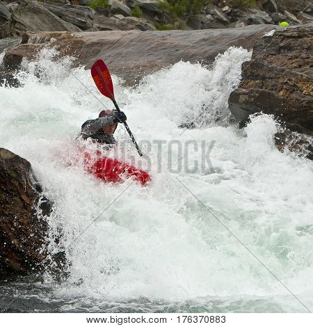 Kayaker in the waterfall in Norway Ula river