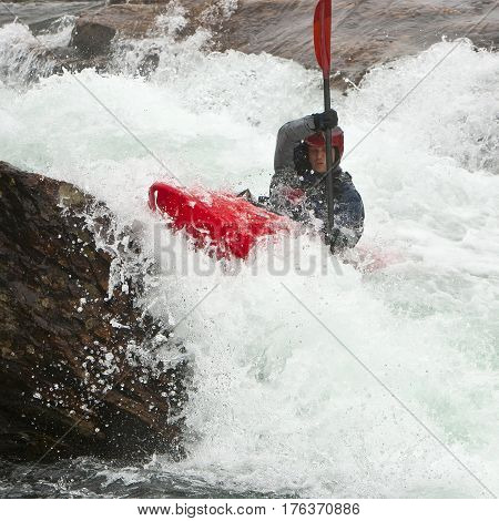 Kayaker in the waterfall in Norway Ula river
