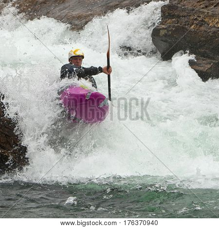 Kayaker in the waterfall in Norway Ula river