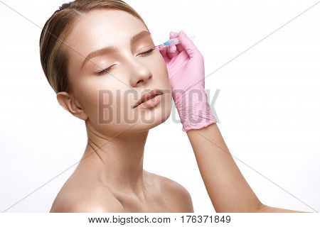 Young girl with a healthy skin and Nude makeup. Beautiful model on cosmetic procedures botox. Injections of beauty and youth. The beauty of the face