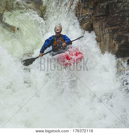 Kayaker in the waterfall in Norway Ula river