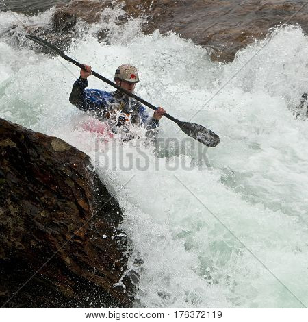 Kayaker in the waterfall in Norway Ula river