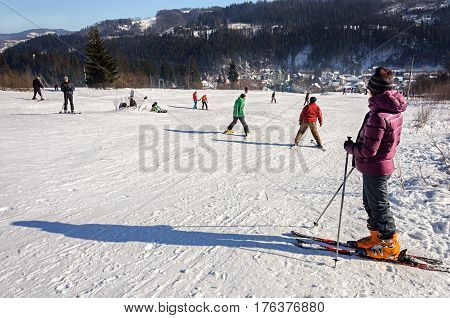 Slavske Ukraine - January 30 2017: People skiing on mountain in ski resort Slavske Carpathians. Sunny winter day