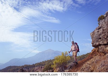 Summer hiking in the mountains with a backpack .