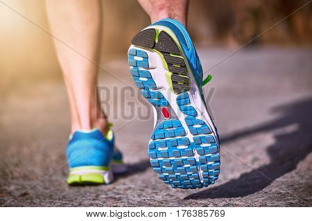 Running athlete during training outdoors in the summer on a sunny day.