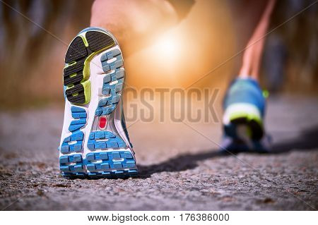 Running athlete during training outdoors in the summer on a sunny day.