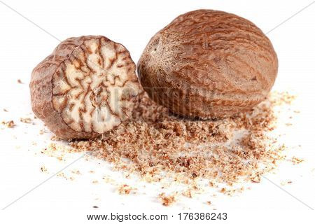 Two nutmeg and powder isolated on white background.