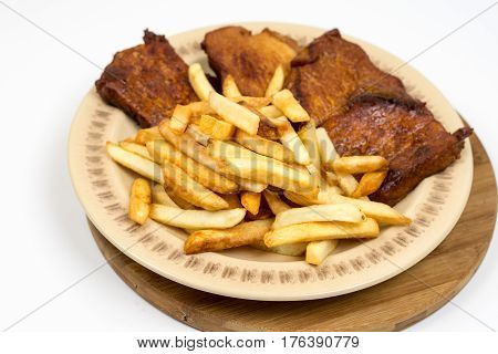 Baked Pork Chops With French Fries Served On The Plate