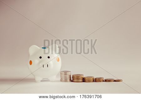White piggy bank or money box with money coins