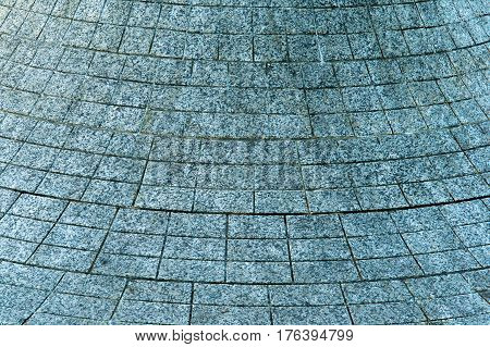 paving slabs in a circle the tiles covering the bulge of the fountain