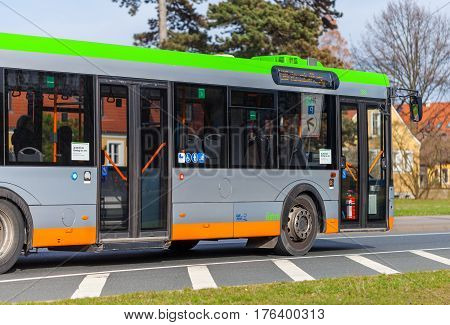 HANNOVER / GERMANY - MARCH 12 2017: regular bus from UESTRA drives on route to the next stop. UESTRA is the operator of public transport in the city of Hanover Germany