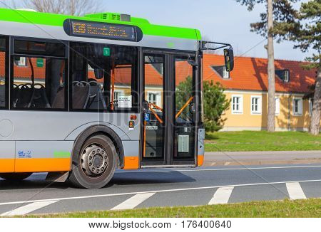 HANNOVER / GERMANY - MARCH 12 2017: regular bus from UESTRA drives on route to the next stop. UESTRA is the operator of public transport in the city of Hanover Germany