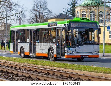 HANNOVER / GERMANY - MARCH 12 2017: regular bus from UESTRA drives on route to the next stop. UESTRA is the operator of public transport in the city of Hanover Germany