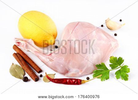 Leg of rabbit and spices isolated on white background close up. Ingredients for dietary dishes from the rabbit.