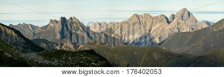 Great clear view from high mountain over other peaks in evening or morning sunlight. Alps, Bavaria, Tirol, Allgau.