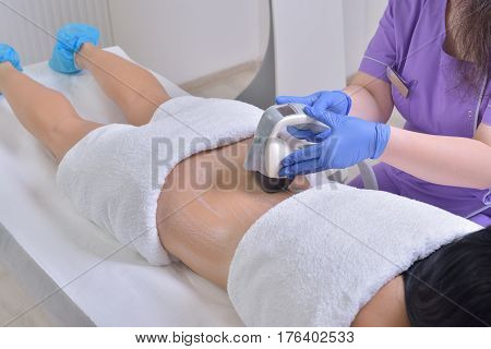 Young beautiful woman gets professional skin treatment in a professional beauty clinic. Body shaper