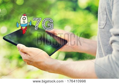 7G Concept With Man Holding Tablet